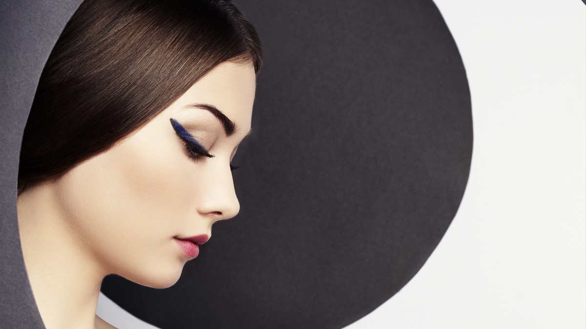 A woman with long black eyeliner on her nose.