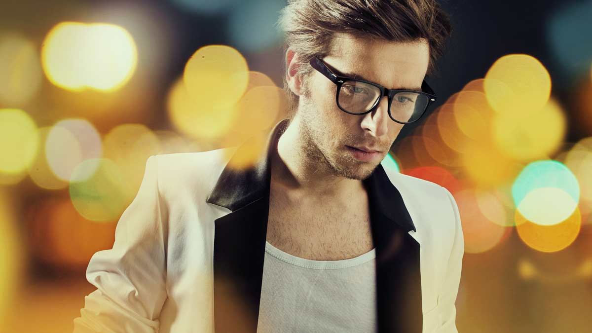 A man with glasses and a white jacket