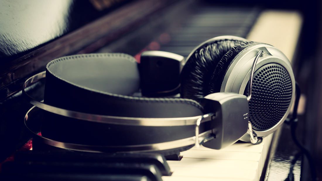 A pair of headphones sitting on top of piano keys.