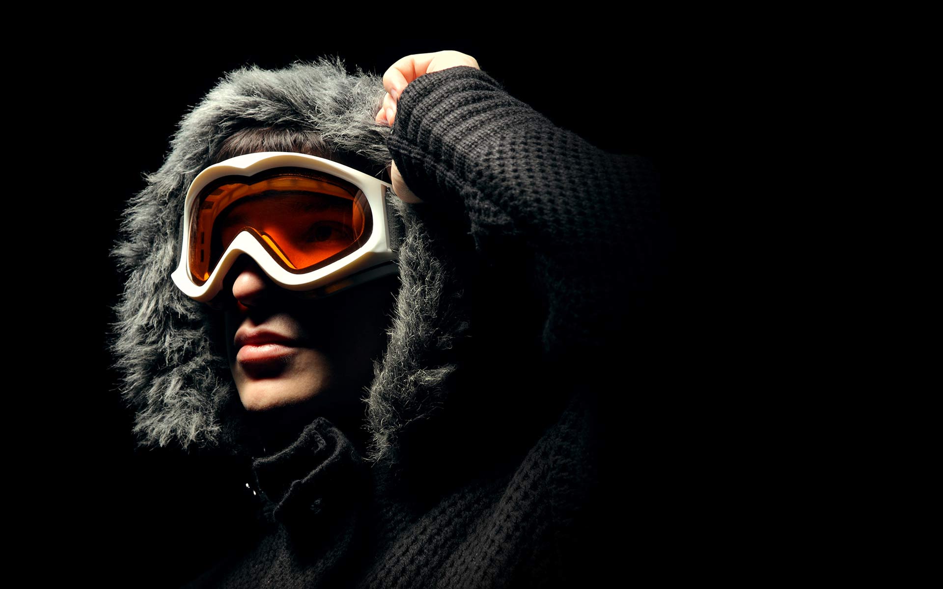 A person wearing goggles and a jacket